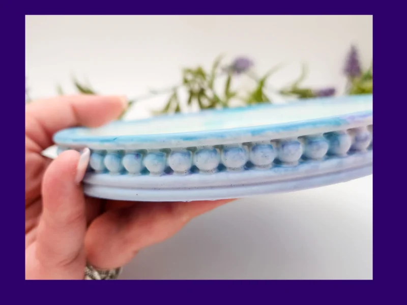 Side view of the snowman tray showing the blue marble border and raised bobble edge texture.