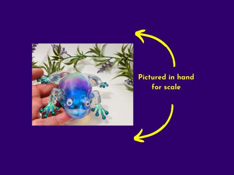 Aurora resin frog held in hand to show size and scale.
