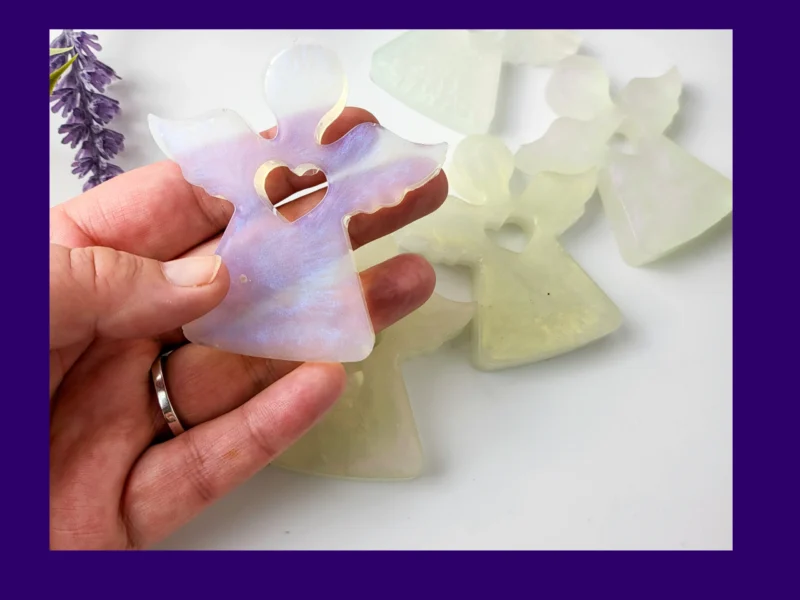 Close-up photo of a single translucent resin Guardian Angel with heart cut-out.