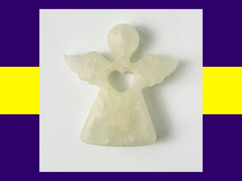 Hand holding a resin Guardian Angel in the green translucent colour variant.