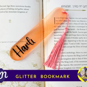 glitter personalised resin bookmark displayed on an open book with tassel.