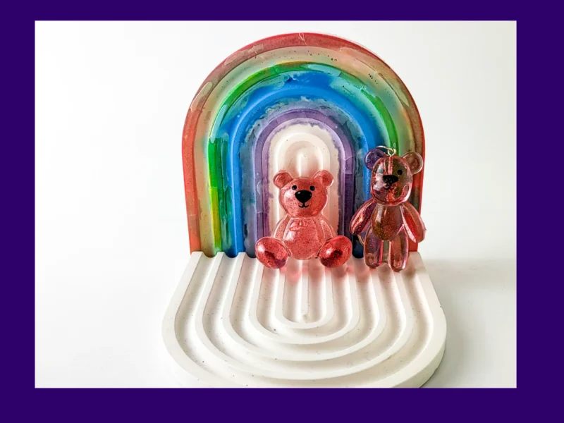 red resin Worry Bear handheld and keyring pair displayed on white rainbow arch tray – small resin worry bears for anxiety