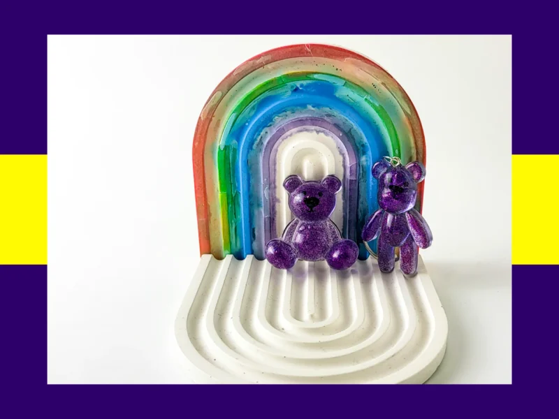 Purple resin Worry Bear handheld and keyring pair displayed on white rainbow arch tray – pocket calming bears