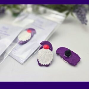 Packaged purple gnome pin on Kirnix Creations backing card inside a clear sleeve, shown front-on