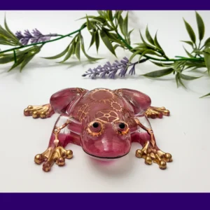 Front view of handmade steampunk resin frog with metallic gears and gold-painted toes.