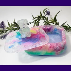 Open candycore resin treasure box showing the inside, with the lid tilted and the glitter teddy visible on top.