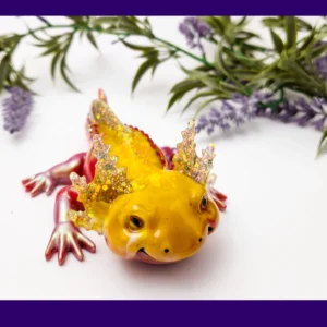 Front view of yellow-and-red Sparkle Axolotl resin figurine