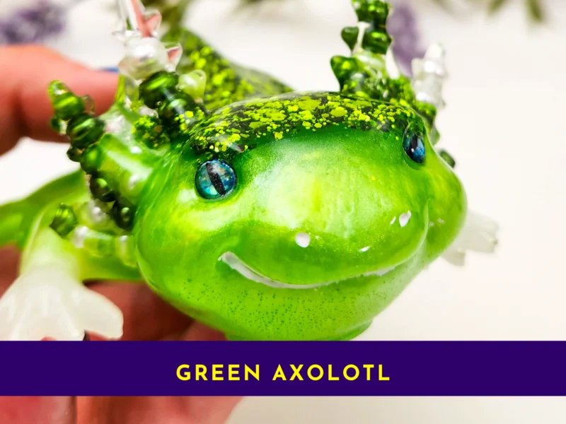 Close-up of green resin axolotl face showing shimmer and blue eyes.