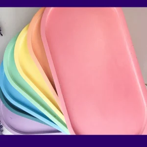 Fan-stacked large oval eco-resin trays in multiple colours, showing the available colour options for the Large Oval Tray listing.