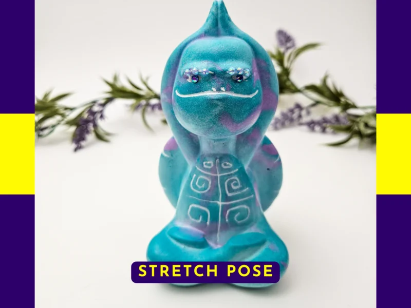 “Front-facing hero shot of the Stretch Pose Aqua Zen Turtle, featuring its raised arms, teal and purple swirl resin and decorative shell.”