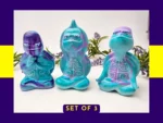 “Aqua Zen Turtle Trio shown together in their Meditation, Calming and Stretch poses with a ‘Set of 3’ label on a purple background.”