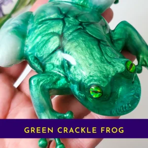 “Handheld view of the OOAK green crackle resin frog showing detailed crackle texture and glossy finish.”