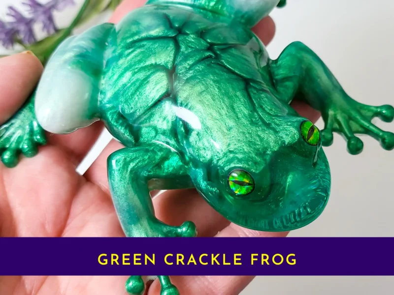 “Handheld view of the OOAK green crackle resin frog showing detailed crackle texture and glossy finish.”