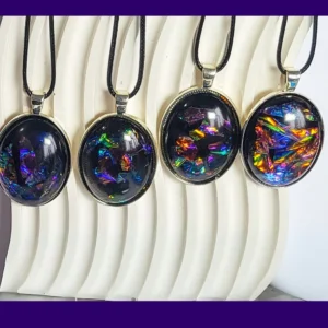 Four Rainbow Eclipse resin pendant necklaces on black cords, oval silver-tone settings with rainbow iridescent flashes.