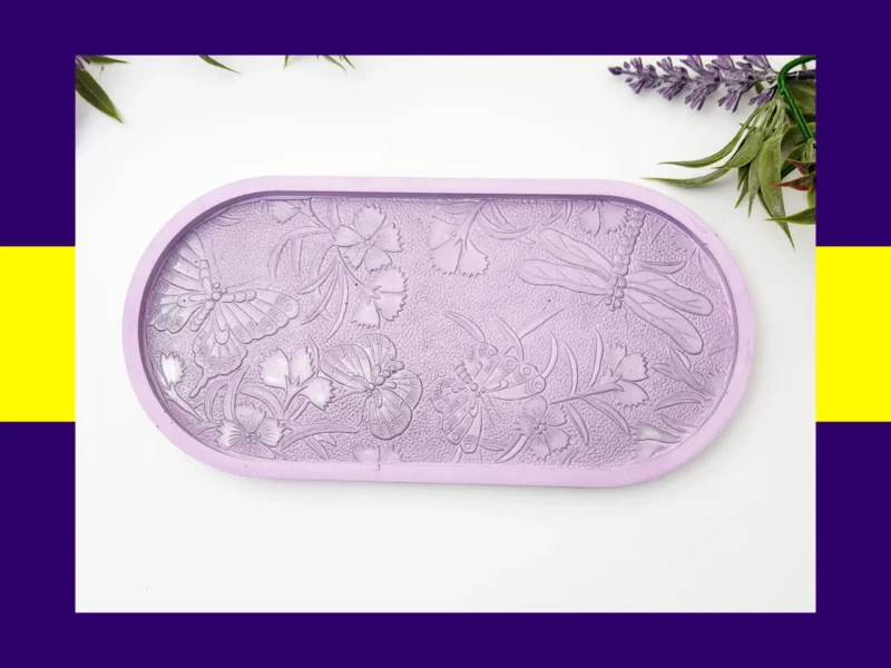 “Front view of pastel resin trinket tray featuring raised dragonflies, butterflies and floral details.”