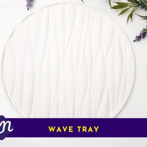 White round wave-textured tray on a white background with greenery and lavender, with a purple banner label reading “Wave Tray”.