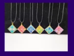 OOO-UVR-001_002 Six one-of-one square resin pendant necklaces lined up on cords, showing different colour designs.