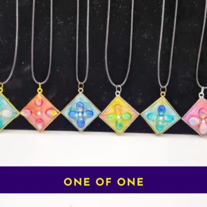 Row of six one-of-one resin pendant necklaces with “ONE OF ONE” text banner underneath.