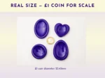Resin worry stones shown beside a £1 coin for real-size scale reference.