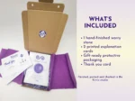 Open gift-ready box showing one resin worry stone, explanation cards, protective packaging, and thank you card.