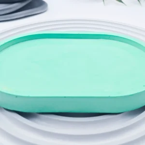 green small oval eco resin tray close-up, smooth sealed surface and raised edge detail, UK handmade home organiser.