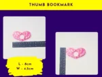Thumb bookmark size graphic showing heart-shaped pink glitter thumb bookmark next to rulers (labelled “Thumb Bookmark”).