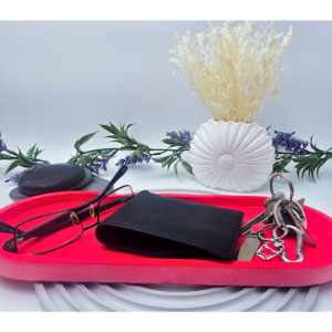 RED extra large oval catchall tray holding keys and a black wallet.