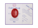 Red resin worry stone displayed on a printed backing card with a matching meaning card.