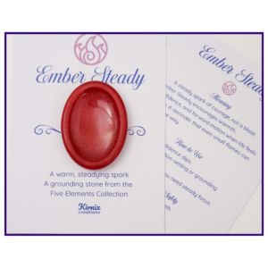 Red resin worry stone displayed on a printed backing card with a matching meaning card.