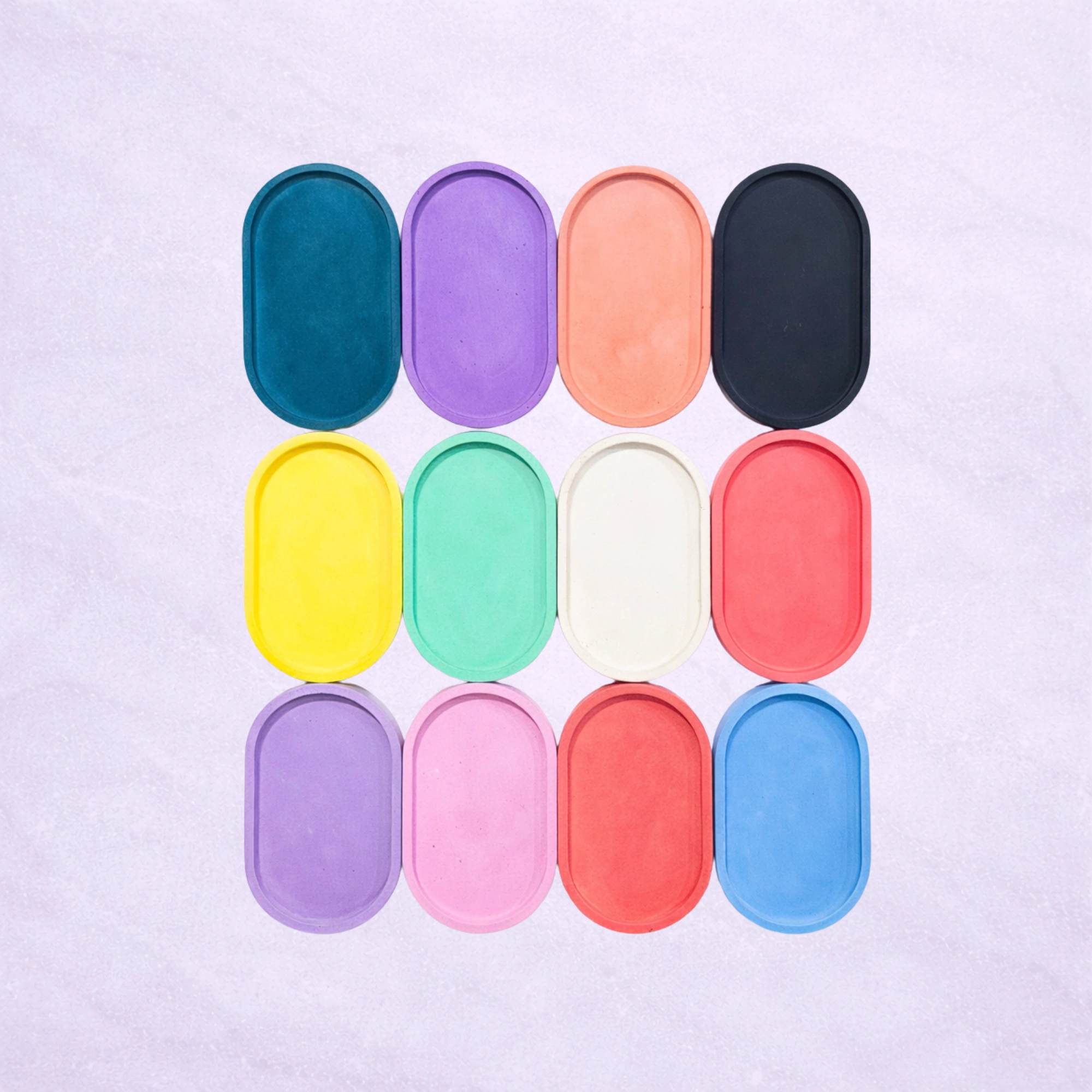 Lavendar background with Eco Resin Oval Tray ideal to use as a catchall. In red, yellow, orange, green, blue, indigo, violet, pink, white and black