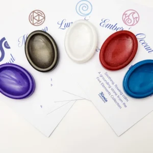 Five oval resin sample stones in purple, black-gold, white, red and blue displayed on branded Kirnix Creations Five Elements Collection cards.