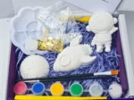 Open box paint your own space kit with astronaut rocket planet paints brushes and glitter