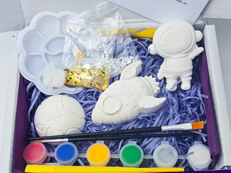 Open box paint your own space kit with astronaut rocket planet paints brushes and glitter