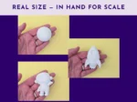 Astronaut and rocket plaster shapes held in hand showing real size for scale
