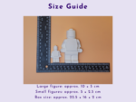 Size guide image showing white blocky figures beside a ruler on an orange background to indicate scale (approx 10×5 cm).