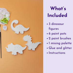 Craft kit page: dinosaur-shaped white cutouts with paints, glitter, and brushes on an orange surface beside a lavender panel listing included items on the right.