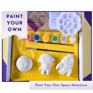 Hero product image showing a boxed paint your own space adventure kit with blank astronaut, rocket and planet shapes, paint pots and glitter