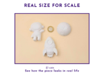 Real size for scale graphic showing the astronaut, rocket and planet shapes beside a £1 coin