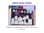 Open paint your own mini village kit with white house figures, paints, brushes, glitter and packaging.