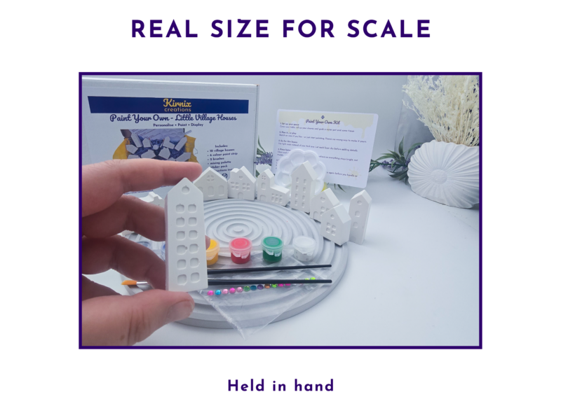 Real size for scale image showing the mini village kit held in hand.