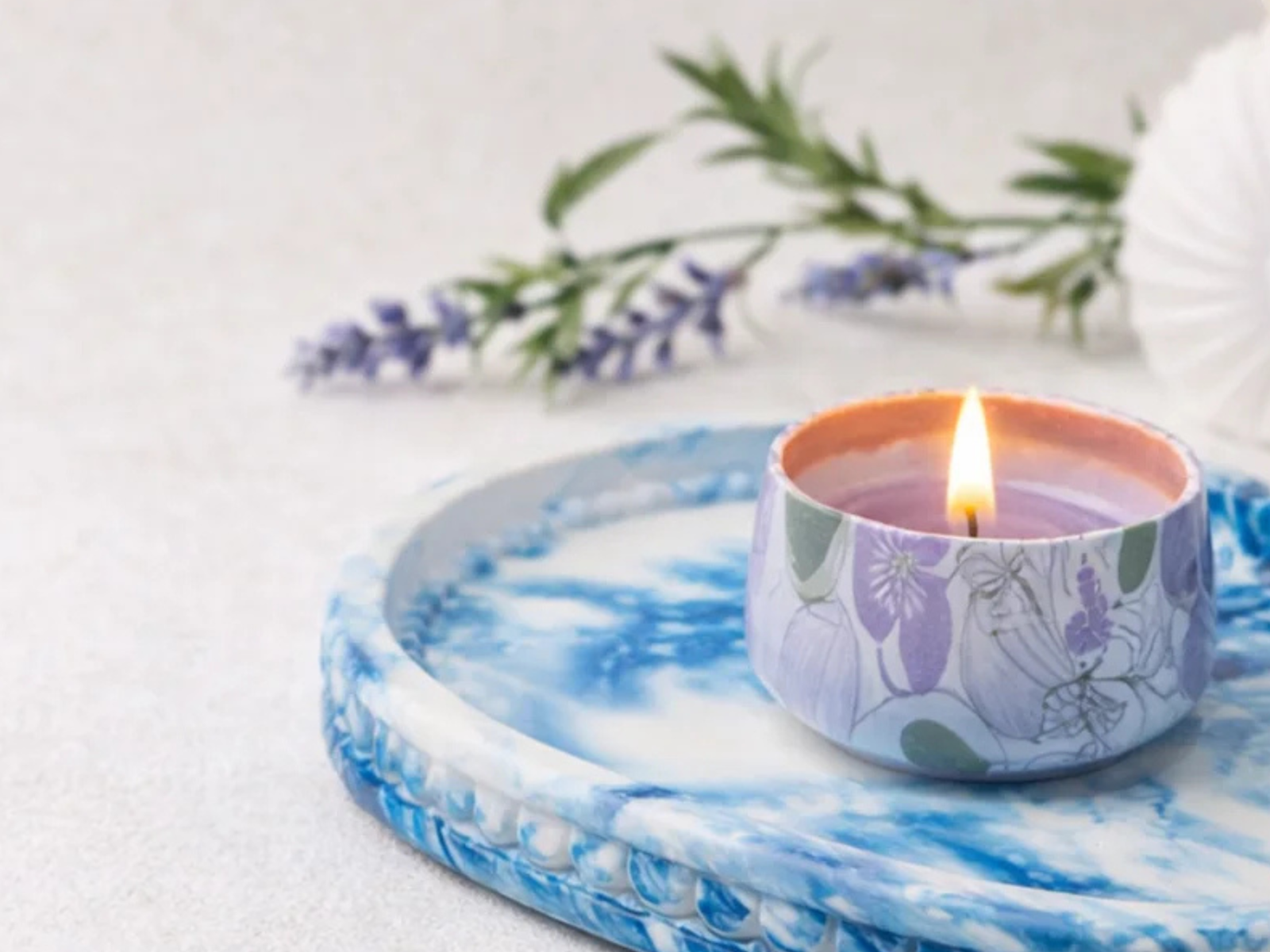 ECO RESIN
Blue and white eco resin tray with a lit floral candle, styled in soft natural light on a marble-effect round tray