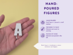 Close-up of a hand holding a small white plastic component against a pale yellow background, with an adjacent purple infographic panel on the right side indicating steps or features.