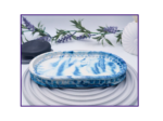 Large blue marble oval catchall tray shown empty on a pale ribbed surface.