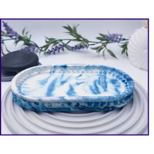 Large blue marble oval catchall tray shown empty on a pale ribbed surface.