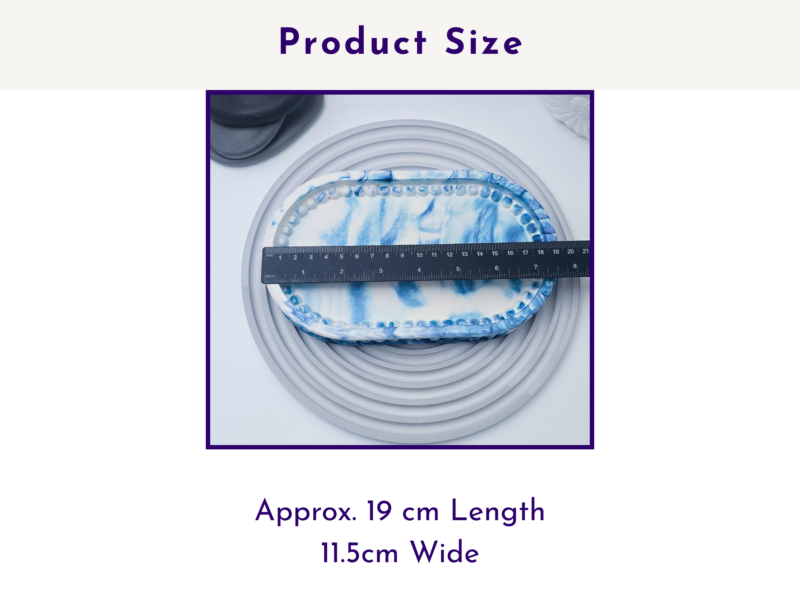 Blue marble oval tray with a measuring tape across it to show product size.