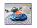 Small oval blue and white marbled tray styled with a candle and neutral décor