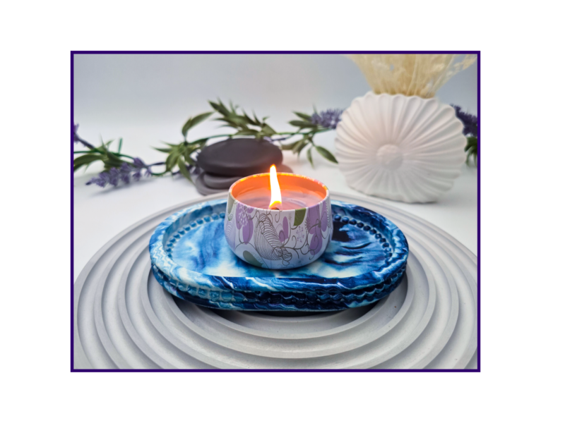 Small oval blue and white marbled tray styled with a candle and neutral décor