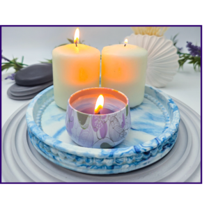 Small blue and white marbled oval catchall tray styled with a candle on a ribbed grey mat