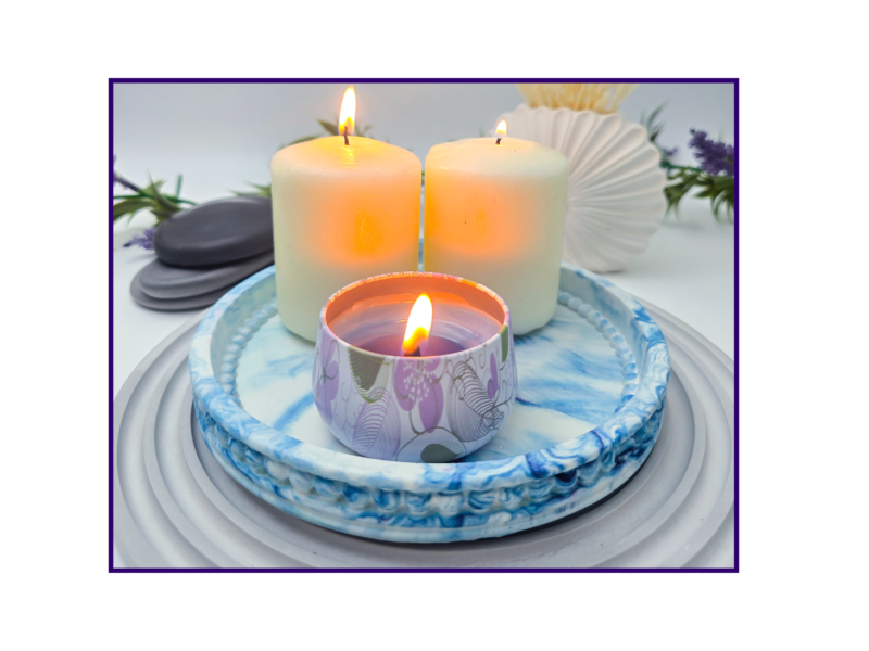 Small blue and white marbled oval catchall tray styled with a candle on a ribbed grey mat