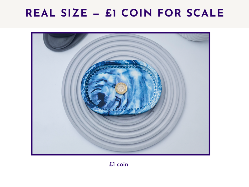 Small oval marbled tray shown with a £1 coin for size scale